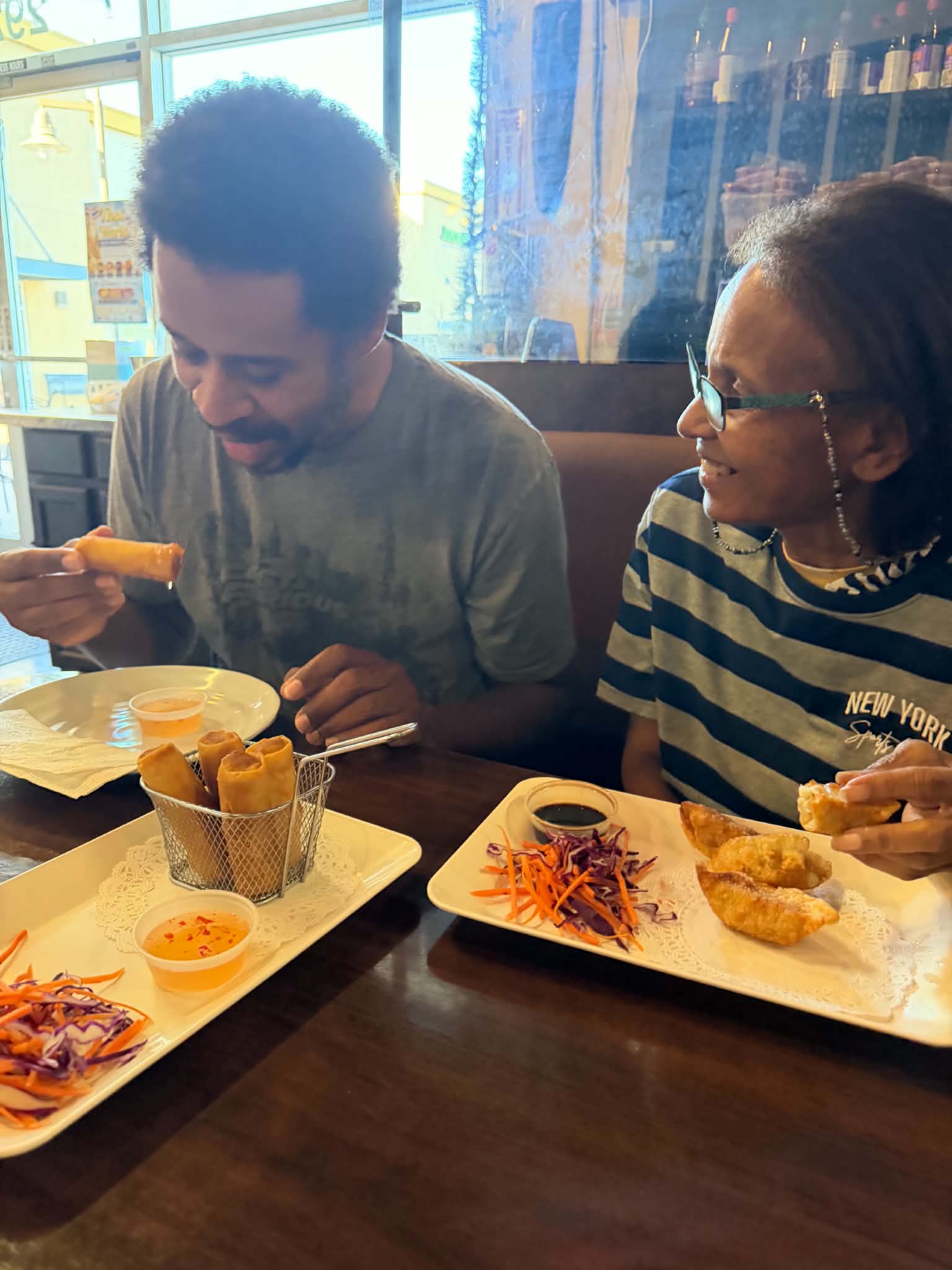 Sir Kev and JES smiling over spring rolls and potstickers during his birthday meal