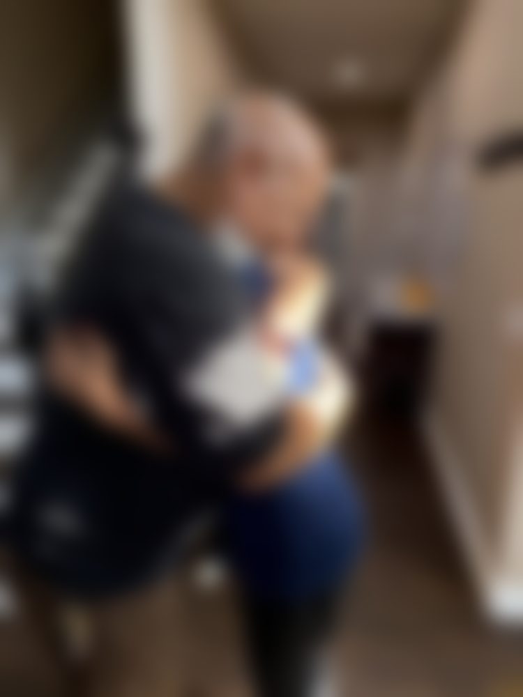 A tender moment during moving-in day at Golden Days, with faces softened for privacy